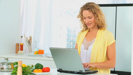 curly haired woman looking at a recipe