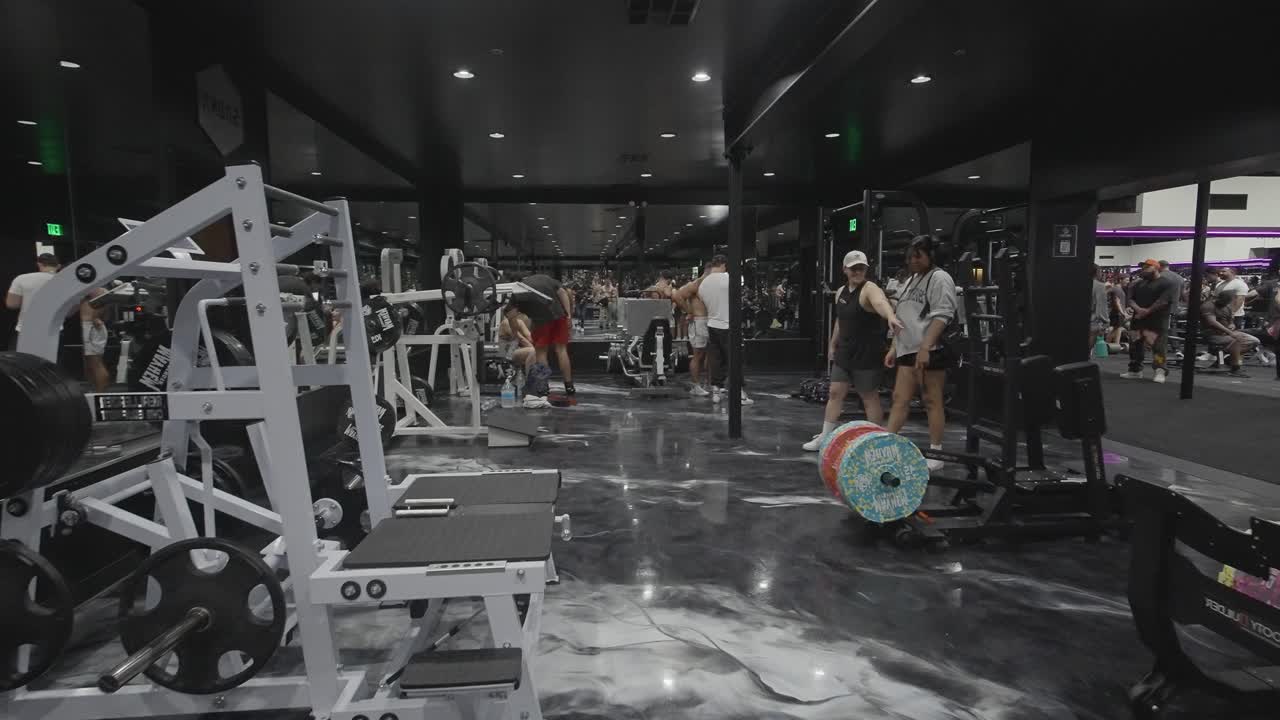People exercising and training in a modern gym with various fitness equipment