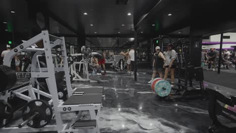 people exercising and training in a modern gym with various fitness equipment