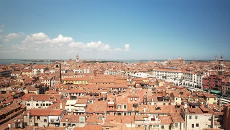 aerial drone fly above venice italy in summer warm day, rialto bridge over grand canal, buildings and architecture, travel and tourism in europe