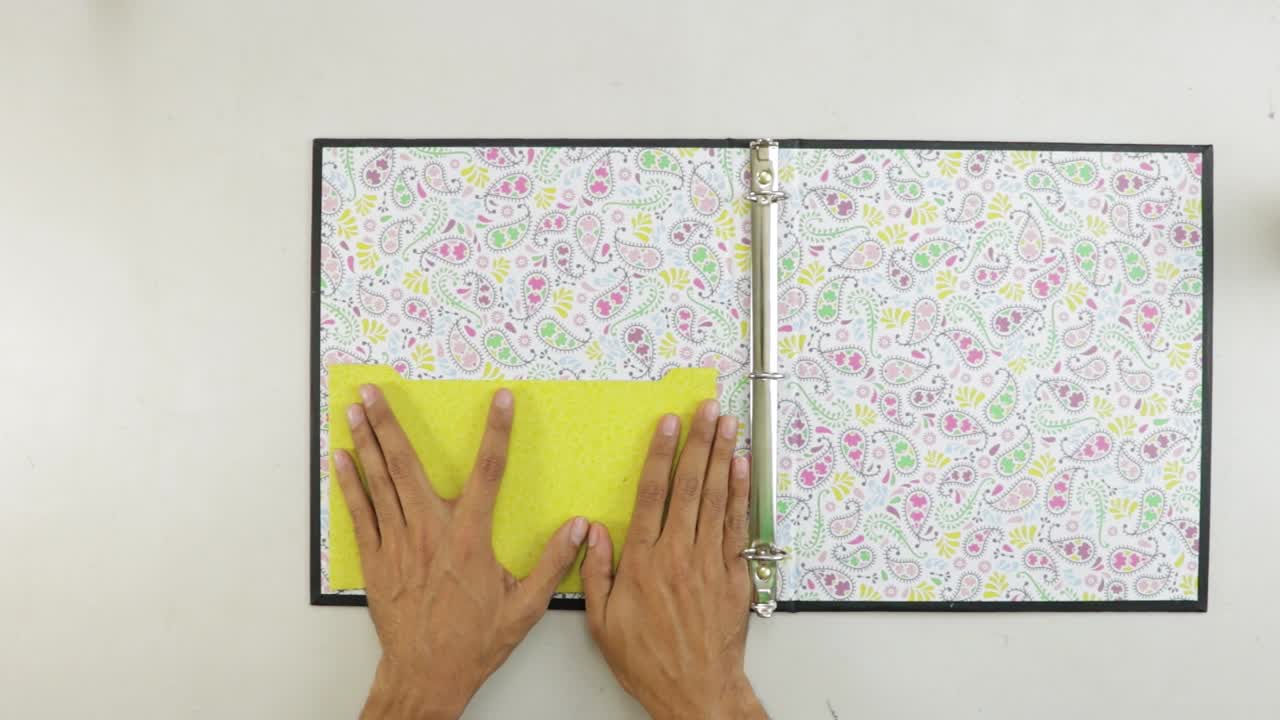 pegar un sobre amarillo a la cubierta interior de un archivo de palanca de arco decorado