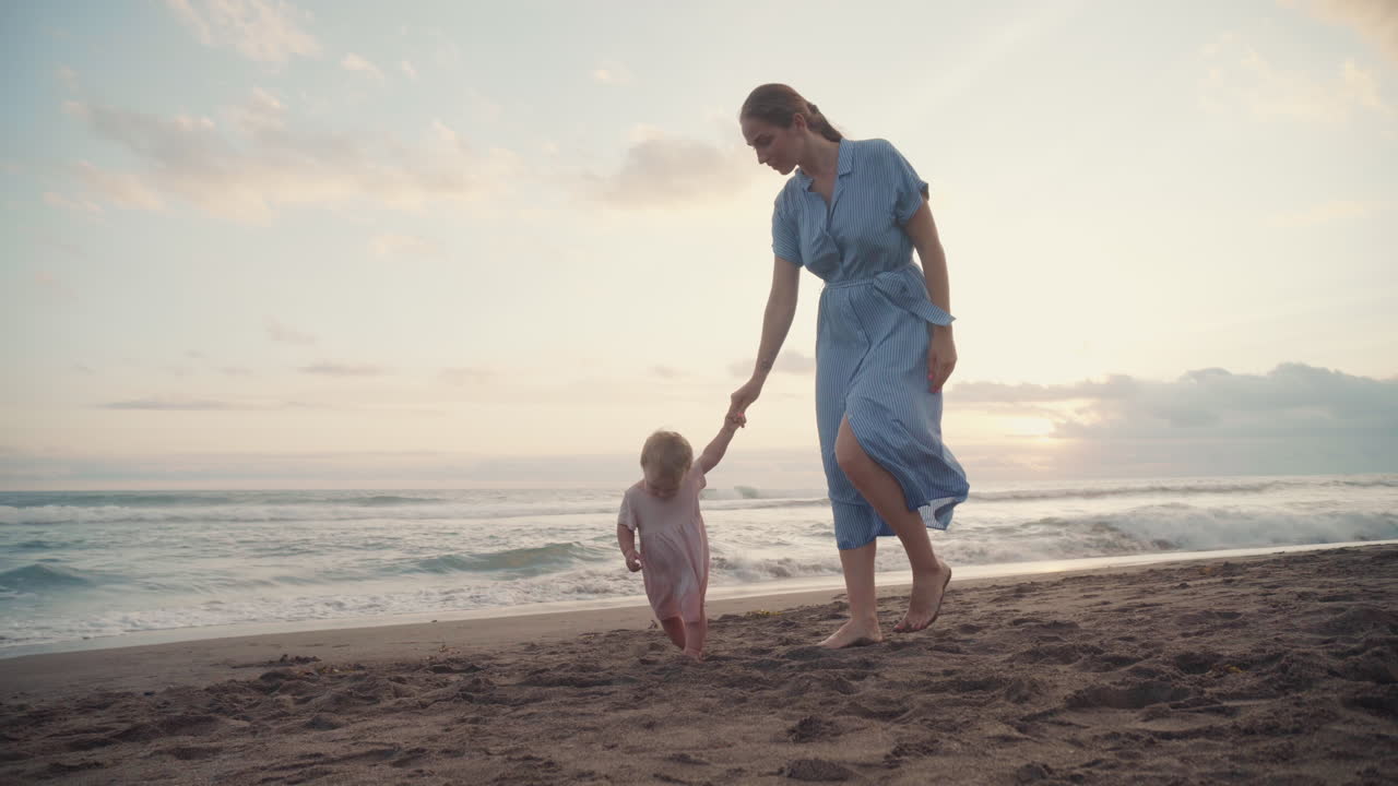 Family Walking by Ocean on Sunset