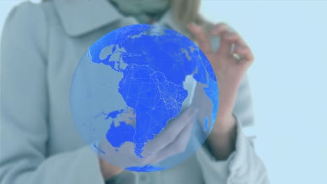 animation of shapes and globe over caucasian woman using smartphone