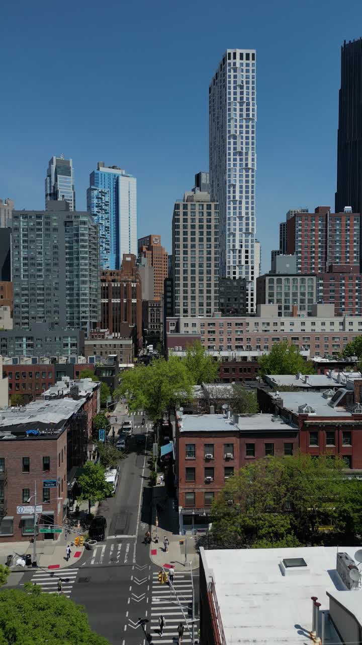 Vertical drone footage showcasing a push-in shot over Bourem Hill, Dumbo, Brooklyn, capturing the city's urban skyline and architecture. Perfect for stock footage of New York's dynamic cityscape.
