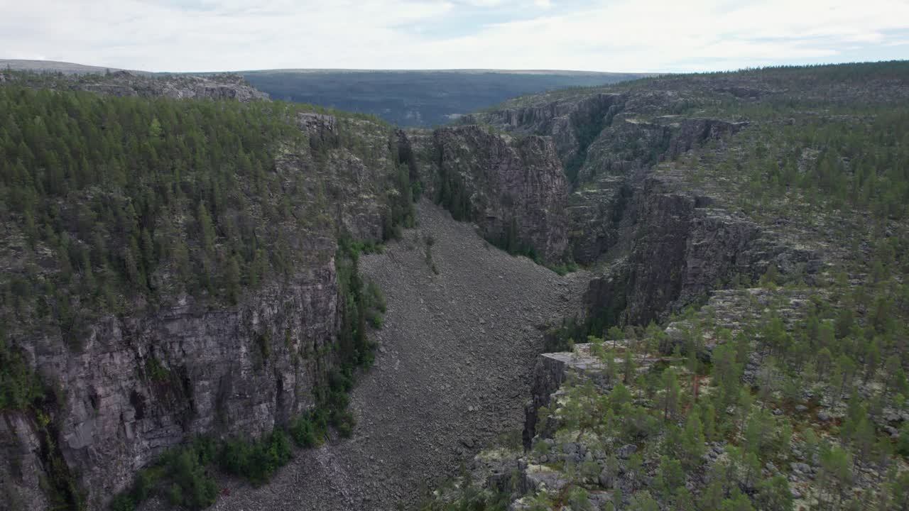 A dolly-in drone shot of a scree field in Norway's Jutulhogget canyon