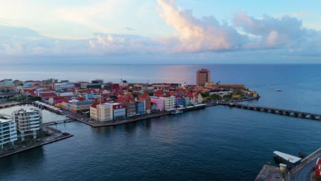 Aerial-ascend-establishing-view-of-Willemstad-Curacao-UNESCO-World-heritage-buildings-at-sunrise