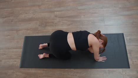 woman practicing yoga on a mat