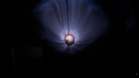 macro of the hypnotic effect of a blue pill dissolved in water with translucent waves