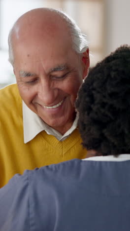 a happy elderly man and a young man hugging each other