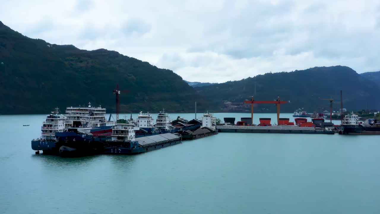Industrial factory real shot of Shipbuilding and ship repair yard. Shipyard contains many cranes, dry docks, slipways, warehouses, painting facilities and large areas for fabrication of ships