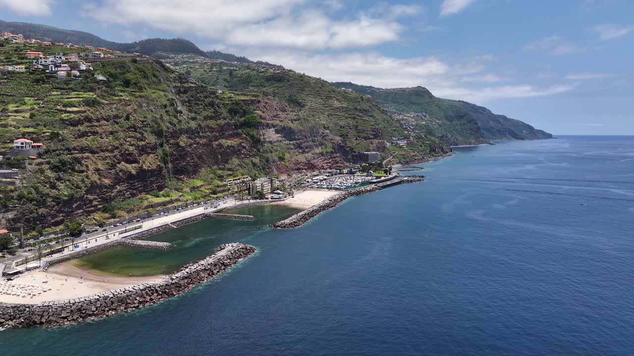 Seaside resort of Calheta with sandy beaches protected by breakwaters. Aerial