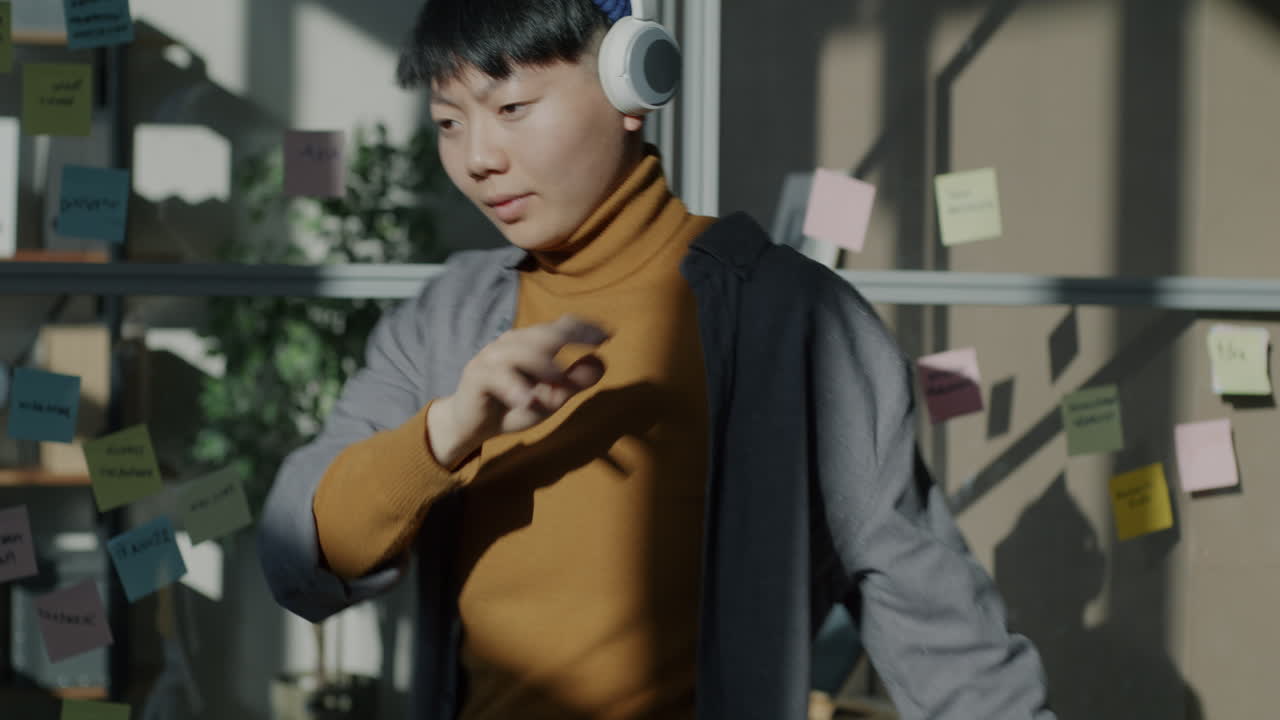 Woman Dancing in the Office with Headphones