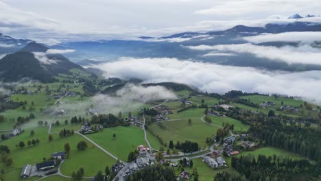 clouds and mist at valley in schladming austria - aerial 4k