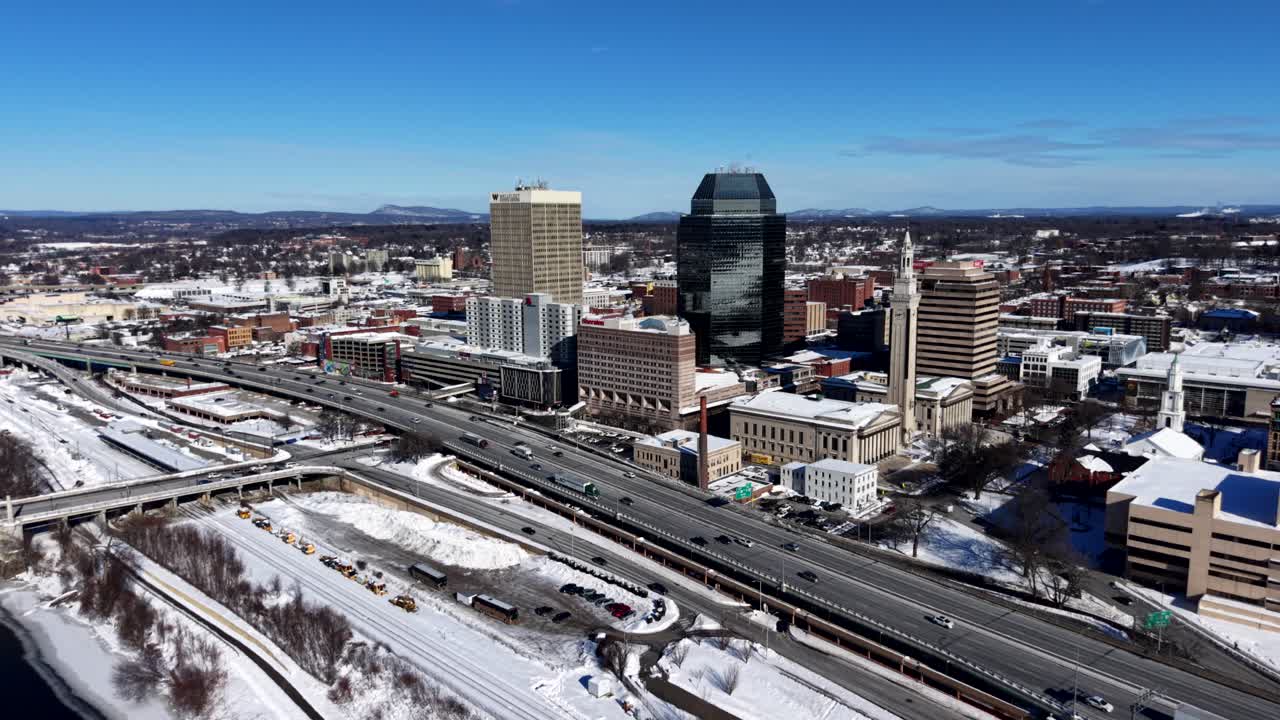 Snowy Springfield cityscape with highways and buildings on a clear day