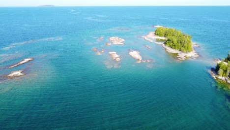 rocky islands and blue lake water in ontario, canada, aerial view