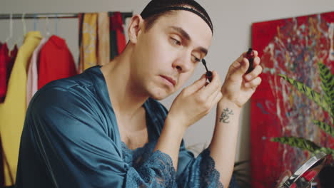 Transgender-Man-Applying-Mascara-while-Doing-Makeup
