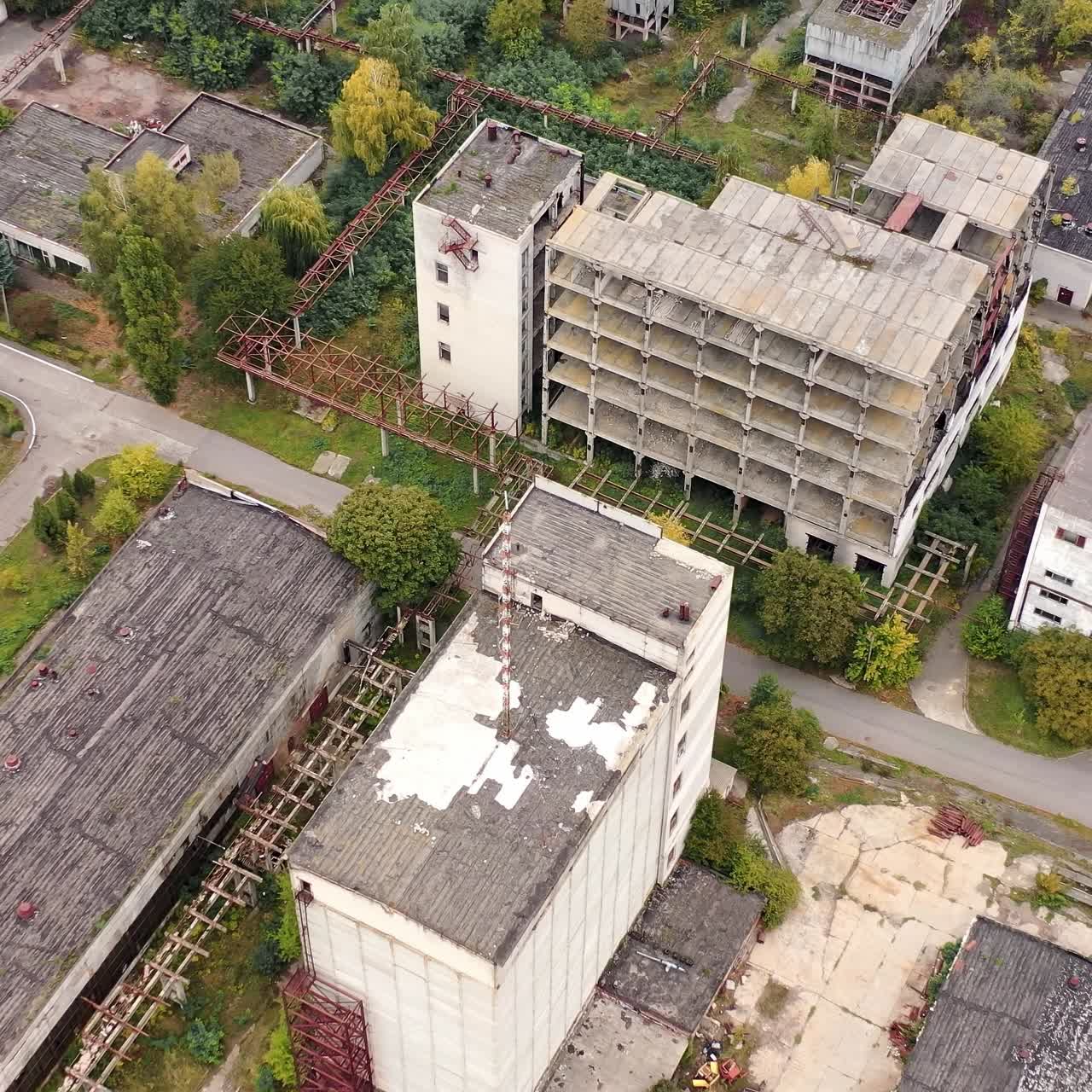 Old manufacture from above. Abandoned industrial territory with old buildings and warehouses. Empty factory. Orbital view