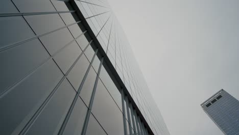 low angle gliding shot of skyscraper in the new york city. financial district. vertical pov dolly style shot.