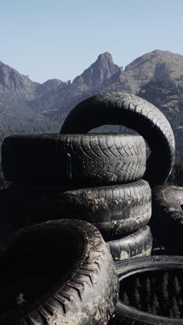 a stack of old tires in the mountains