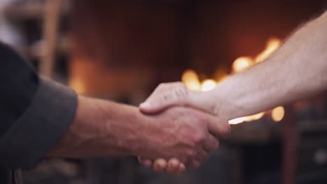 Business handshake in a blacksmith shop