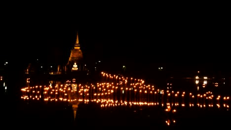 light in buddha statue at temple in loy kratong festival, sukhothai historical park , thailand