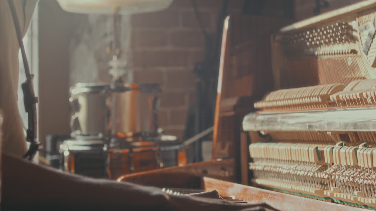 Person Playing Vintage Piano in a Room