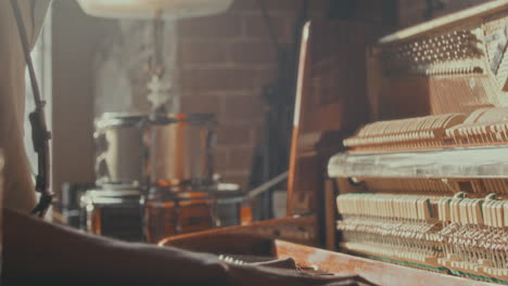 person playing vintage piano in a room
