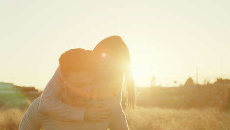 man carries a woman on his back