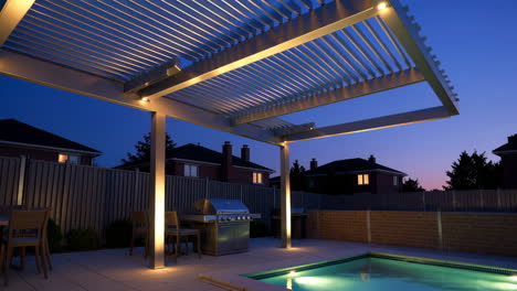 modern outdoor patio with pergola, pool, and grill at twilight