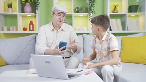 the grandfather, who has poor eyesight, does not use the phone and his grandson helps him.