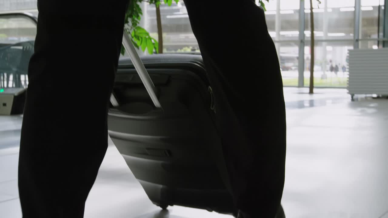 Businessman carrying a suitcase in office 4k