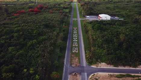 tilt down drone shot of broadway road at tinian island