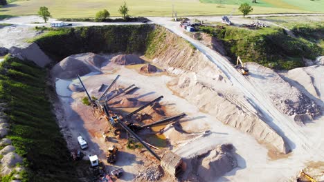 aerial orbit shot from a drone of quarry and heavy machinery in pomeranian district in poland