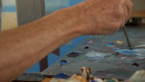 close up of painter loading brush