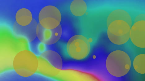 animation of yellow light spots over colourful shapes on blue background