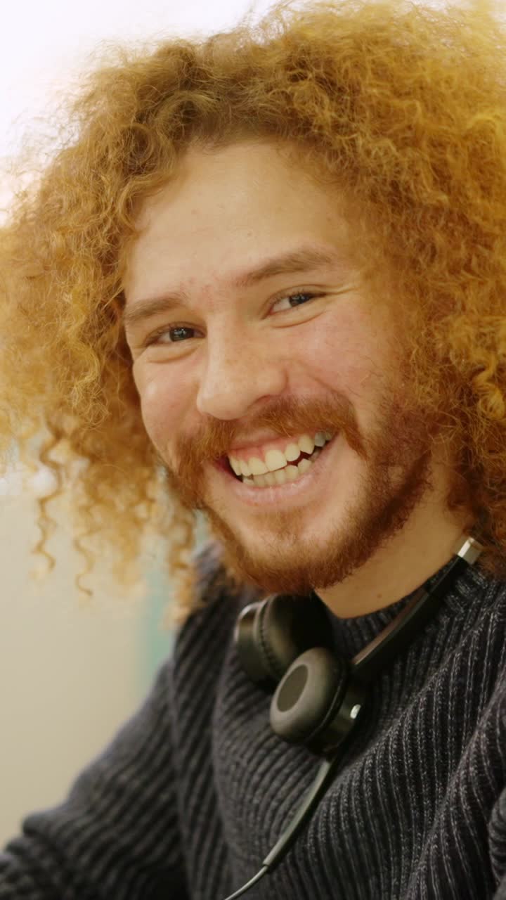 Modern man smiling while working in coworking space