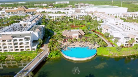 aerial view of hard rock complex resort with private swimming pool beside river in punta cana