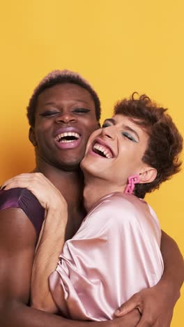 stylish trans people in make up and fashion clothes embracing and smiling