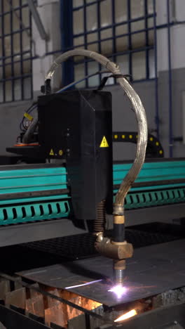 The laser cuts the metal. Industrial equipment for metal cutting. Machine with a laser Vertical video