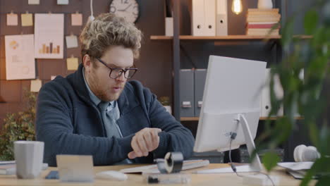 stressed employee checking time in modern office