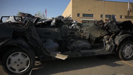 Close-up-of-sedan-missing-roof-after-being-cut-off-by-the-jaws-of-life,-pan