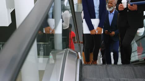 business people using escalator 4k