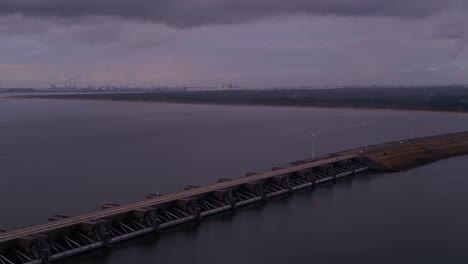 Aerial-View-Of-Haringvlietdam-Crossing-The-Haringvliet-On-Overcast-Dark-Grey-Day