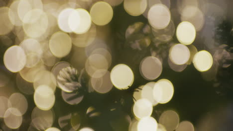 close-up of a beautiful christmas bauble against the background of glowing lights and bokeh