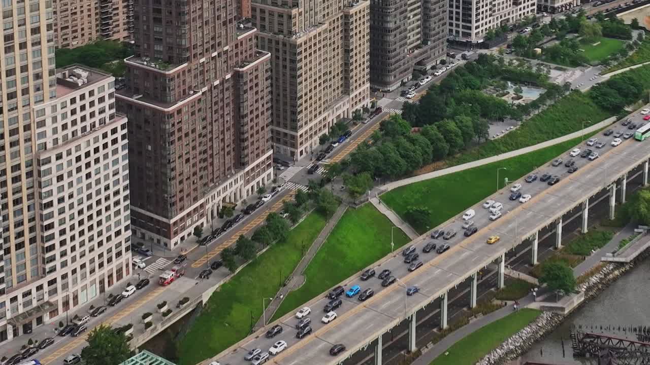 Drone view of busy New York streets with waterfront and greenery