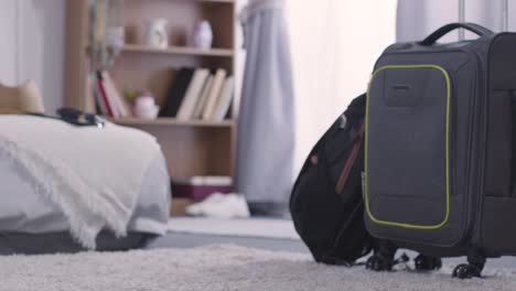 suitcases in bedroom at home packed and ready for summer holiday