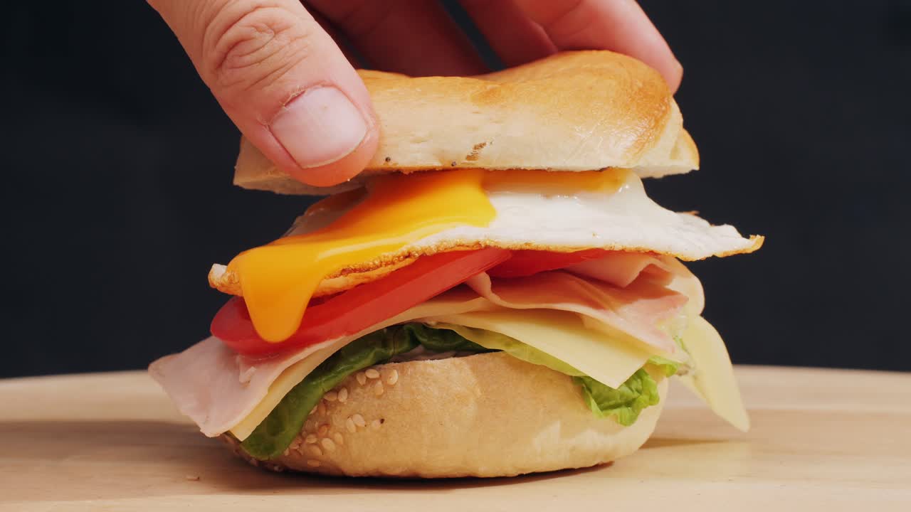 Bagel sandwich brunch, lunch plate of a bagel with smoked salmon and cream cheese and ham, close up morning cafe menu.