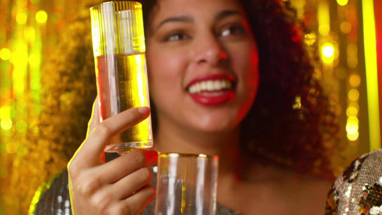 Close Up Of Two Women In Nightclub Or Bar Celebrating Drinking Alcohol With Sparkling Lights 1