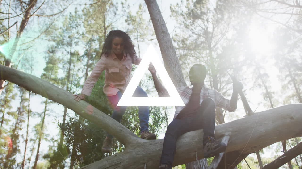 In forest, children climbing tree with glowing geometric animation overlay