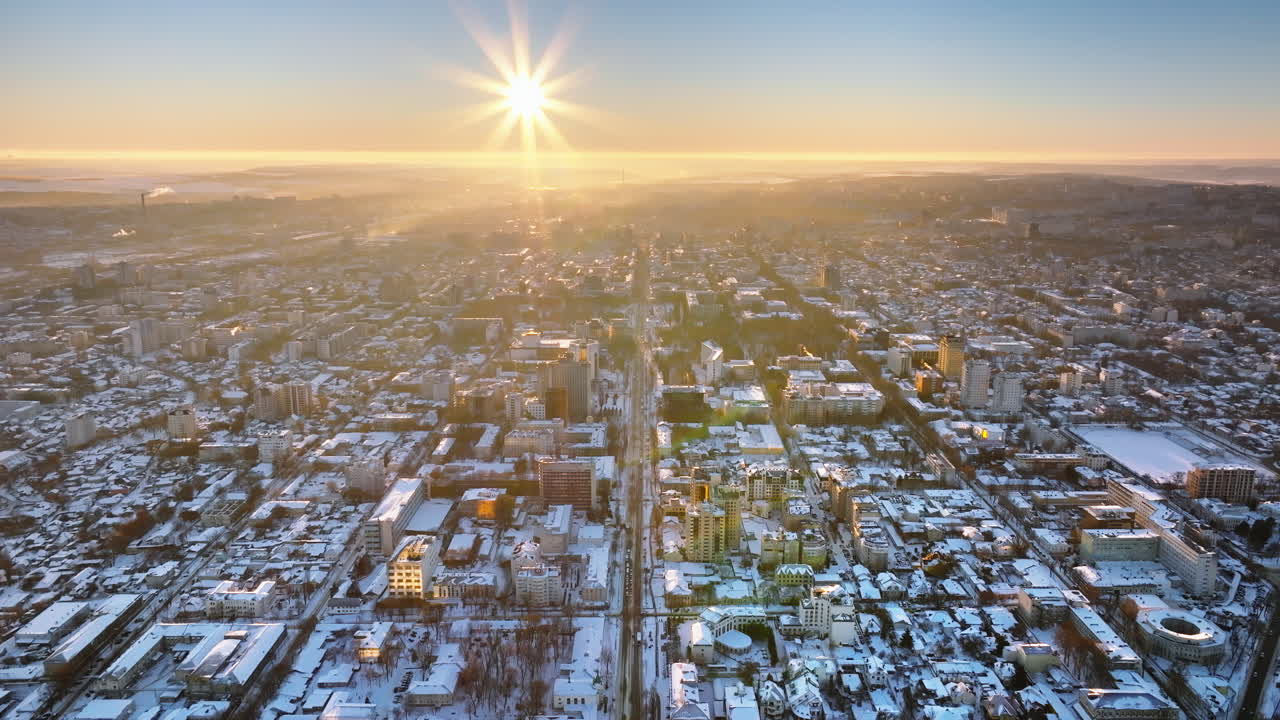 Aerial drone view of the city covered in snow. Sunrise during winter in Chisinau, Moldova